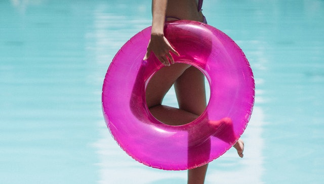Woman holding a pink rubber swimming ring